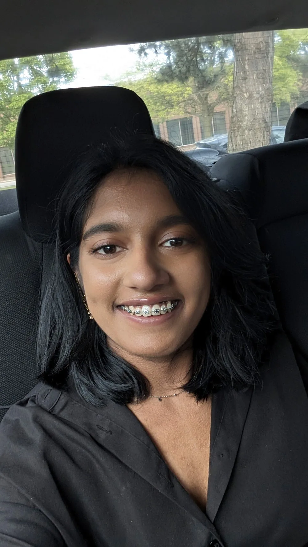 Ashley smiling, sitting in a car