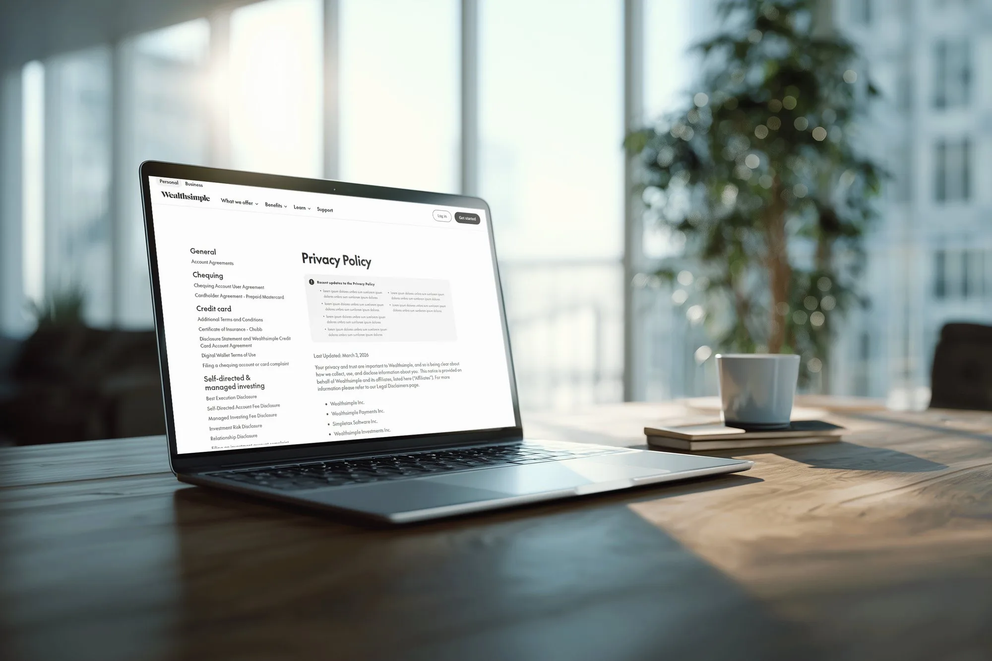 Laptop on a desk showing the redesigned Wealthsimple Privacy Policy page